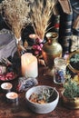 Dried plants, herbs and yellow rose flower petals in a grey, dirty clay pot