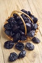 Dried plum in a basket and near Royalty Free Stock Photo