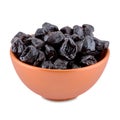 Dried plums or prunes in brown bowl isolated on white background, copy space. Royalty Free Stock Photo