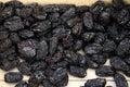 Dried plums or prunes. Dark prunes background. Dry fruit pattern