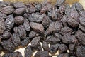 Dried plums or prunes. Dark prunes background. Dry fruit pattern