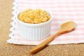 dried pork floss in white cup with wooden spoon on corkboard background. Royalty Free Stock Photo