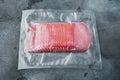 Dried pork meat slices, vacuum packed, on gray stone background Royalty Free Stock Photo