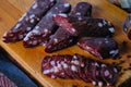 Dried pork sausages composition on a wooden background