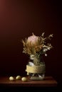 Dried protea flower arrangement in glass pot