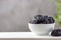 Dried prunes in a white bowl Royalty Free Stock Photo