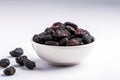 Dried Prunes In A White Bowl On A White Background. Generative AI Royalty Free Stock Photo