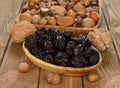 Dried prunes in a wooden bowl Royalty Free Stock Photo