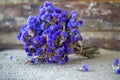 Dried purple wildflowers, wooden background.