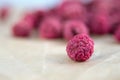 Dried raspberries on craft paper close-up. Dried berries are a useful product for strengthening immunity