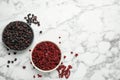 Dried red and black currant berries on white marble table, flat lay. Space for text Royalty Free Stock Photo