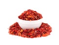Dried red chili flakes in bowl, isolated on white background. Chopped chilli cayenne pepper. Spices and herbs. Royalty Free Stock Photo