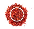 Dried red chili flakes in bowl, isolated on white background. Chopped chilli cayenne pepper. Spices and herbs. Top view. Royalty Free Stock Photo