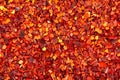 Dried red chili flakes with seeds background. Chopped chilli cayenne pepper. Spices and herbs. Royalty Free Stock Photo