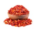 Dried red chili flakes in wooden bowl, isolated on white background. Chopped chilli cayenne pepper. Spices and herbs. Royalty Free Stock Photo