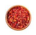 Dried red chili flakes in wooden bowl, isolated on white background. Chopped chilli cayenne pepper. Spices and herbs Royalty Free Stock Photo