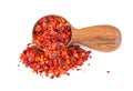 Dried red chili flakes in wooden spoon, isolated on white background. Chopped chilli cayenne pepper. Spices and herbs. Royalty Free Stock Photo