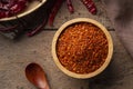 Dried red hot chilli powder in wooden bowl.Hot and spicy asian Condiments Royalty Free Stock Photo