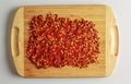 Dried red pepper powder. Background of crushed dry chili peppers on a wooden board Royalty Free Stock Photo