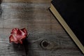 Dried pink rose and old book on wooden background, copy space Royalty Free Stock Photo