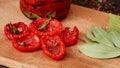 Dried red tomatoes with spices and herbs on wooden board close up Royalty Free Stock Photo