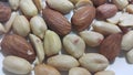 Dried and roasted peanuts and almonds out of shell. A fruit for background