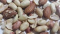 Dried and roasted peanuts and almonds out of shell. A fruit for background