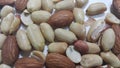 Dried and roasted peanuts and almonds out of shell. A fruit for background