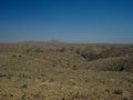 Dried rock desert valley panorama landscape view looking like Mars surface scene with blue sky background Royalty Free Stock Photo