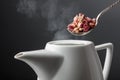 Dried rosebuds are poured into the teapot