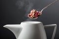 Dried rosebuds are poured into the teapot