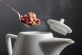 Dried rosebuds are poured into the teapot