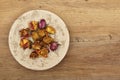 Dried roses on plate, wood Royalty Free Stock Photo