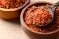 Dried safflower in spoon and bowl