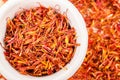 Dried safflower in white bowl.