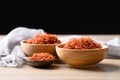 Dried safflower in wooden bowl and spoon