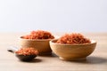 Dried safflower in wooden bowl and spoon