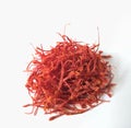 Dried saffron (Crocus sativus) spice on white background.