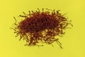 Dried Saffron threads on yellow background. Royalty Free Stock Photo
