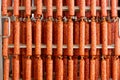 Dried sausage hanging on a rope on a metal frame in the smoke house.