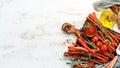 Dried sausages with chili peppers on white wooden background. Chile peppers, Kabanosy. Royalty Free Stock Photo