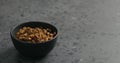 Dried seaberry in black bowl on terrazzo countertop