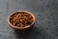 Dried seaberry buckthorn in olive bowl on terrazzo countertop with copy space