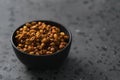 Dried seaberry buckthorn in olive bowl on terrazzo countertop with copy space