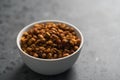 Dried seaberry buckthorn in white bowl on terrazzo countertop with copy space