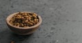 Dried seaberry in olive bowl on terrazzo countertop