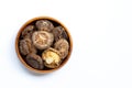 Dried shiitake mushrooms in wooden bowl on white Royalty Free Stock Photo