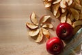 Dried slices of apple and red apples on the table. Top view. Royalty Free Stock Photo