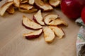 Dried slices of apple and red apples on the table. Top view. Royalty Free Stock Photo