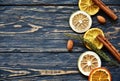 Dried slices of orange and lime, cinnamon sticks and almond on a dark wooden background. Close-up. Royalty Free Stock Photo